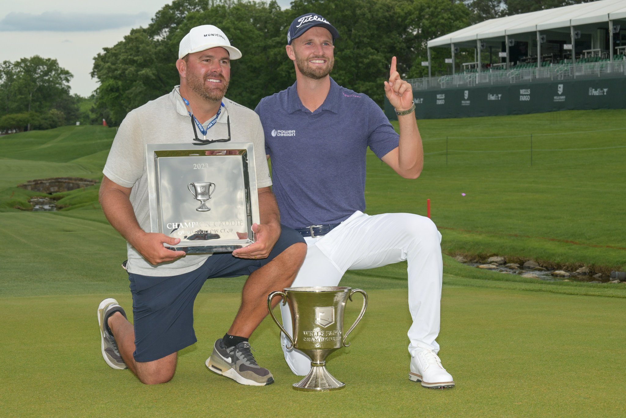 Wells Fargo Championship winner Wyndham Clark and Caddie John Ellis with trophies by Malcolm DeMille